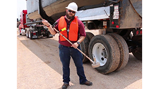 Man holding a Model 30-6 in front of a truck